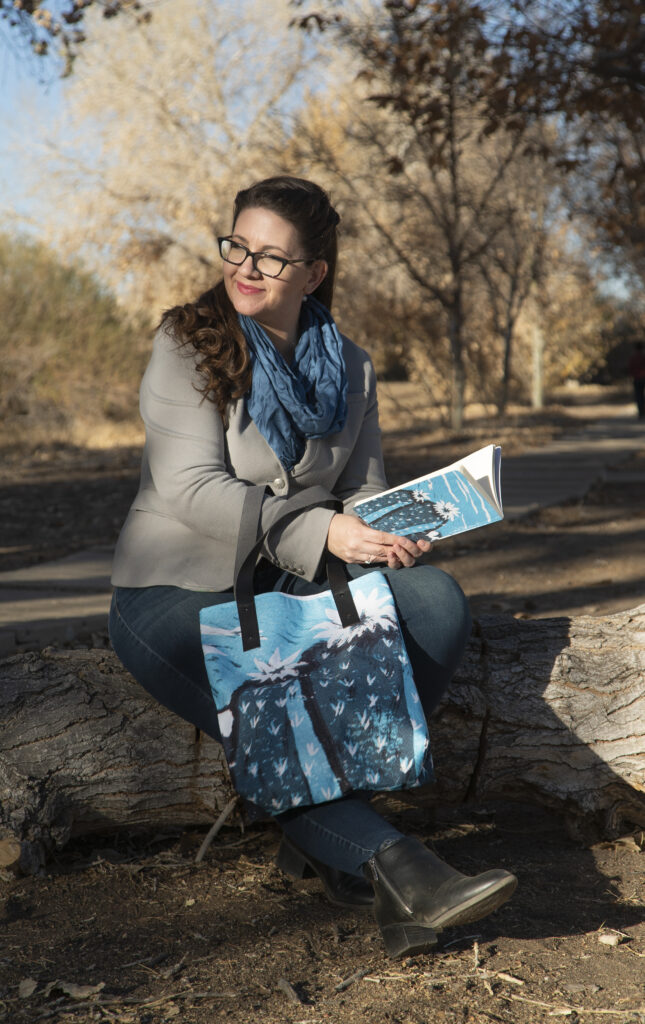 Artist Mary Vasquez with her Cactus Bag and Cactus notebook, all available for sale.